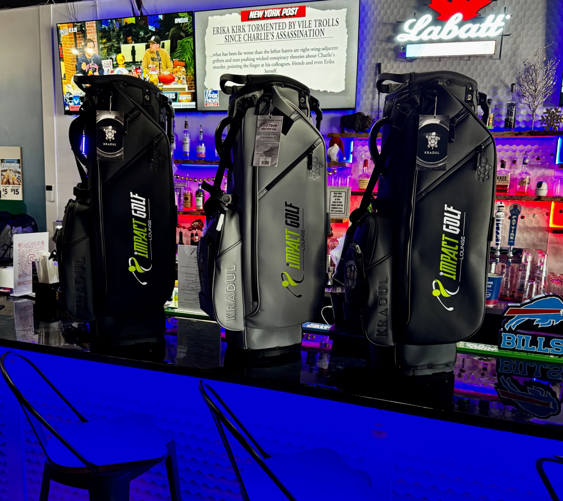 Impact Golf Lounge branded golf bags at the bar